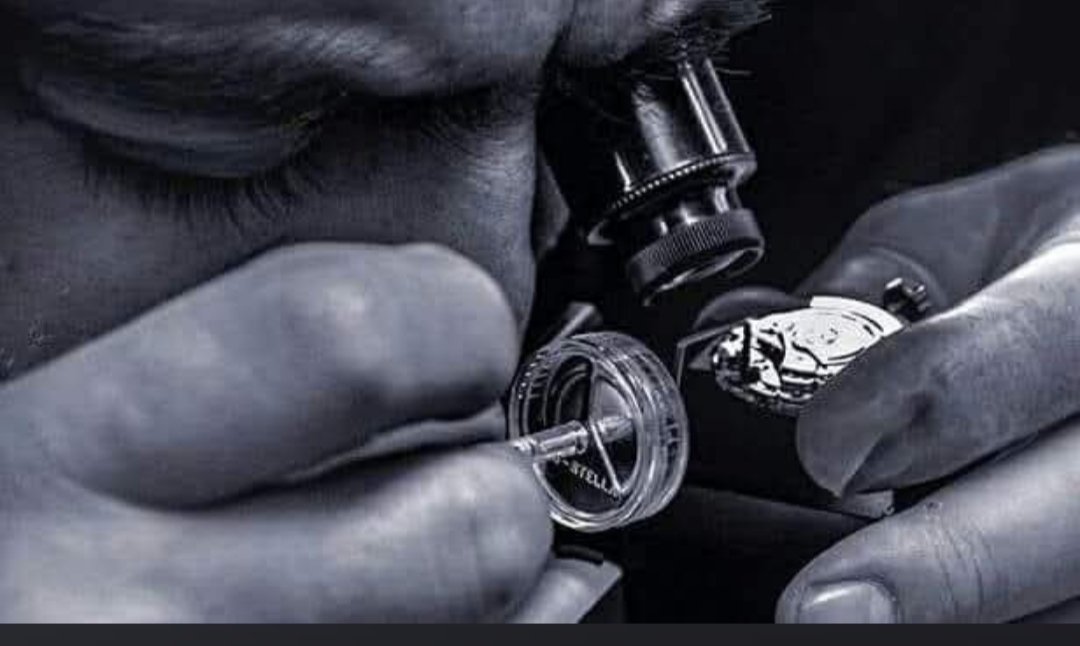 Close-up of the Nautilus team inspecting a mechanical watch movement