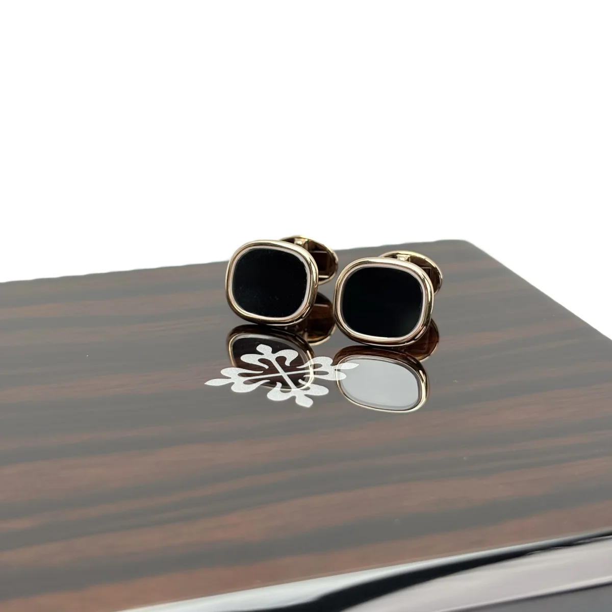 Patek Philippe Black Square Cufflinks — pair beside the Calatrava cross emblem